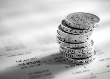 stack of pound coins on financial figures picture id532396653