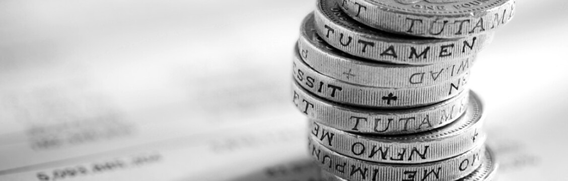 stack of pound coins on financial figures picture id532396653